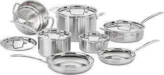 Stainless steel cookware set with polished finish on a modern kitchen stove
