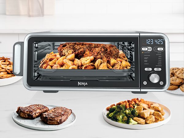 Ninja Foodi Dual Heat Toaster Oven on countertop with golden fries