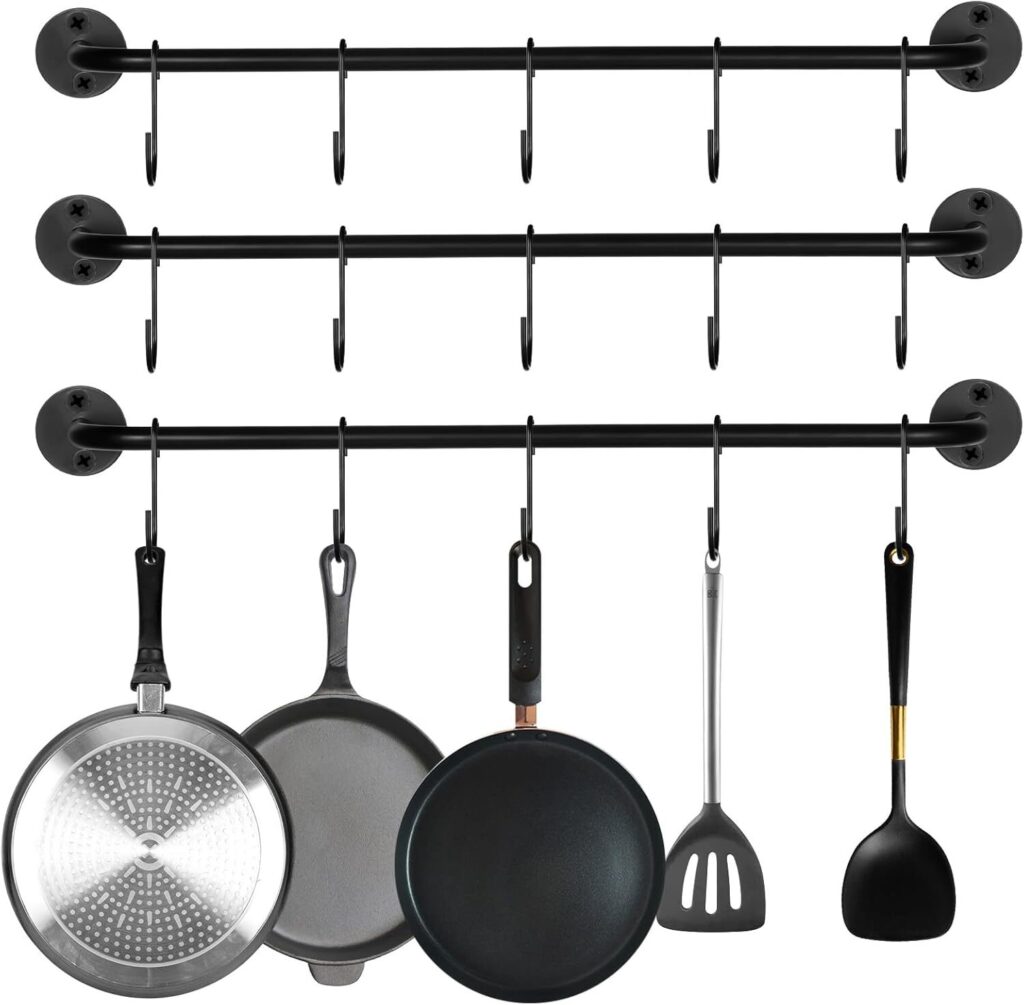Hanging pot rack above a kitchen island holding stainless cookware