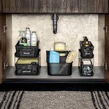 Plastic two-tier under sink organizer used in bathroom cabinet